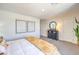 Bright bedroom featuring a black dresser, neutral carpeting, and modern wall art at 5011 Sage Mesa Ave # Lot 143, Las Vegas, NV 89139