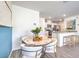 Dining area with a round marble table and modern chairs, open to kitchen at 5011 Sage Mesa Ave # Lot 143, Las Vegas, NV 89139