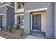Close-up of a townhome entrance featuring a gray front door and desert landscaping at 5011 Sage Mesa Ave # Lot 143, Las Vegas, NV 89139