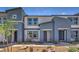 Inviting townhome exterior with modern two-tone paint and low maintenance desert landscaping at 5011 Sage Mesa Ave # Lot 143, Las Vegas, NV 89139