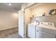 Convenient laundry room featuring a washer, dryer, and shelving for storage at 5011 Sage Mesa Ave # Lot 143, Las Vegas, NV 89139