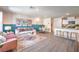 Bright, open-concept living room with modern decor, dining area, and kitchen at 5011 Sage Mesa Ave # Lot 143, Las Vegas, NV 89139