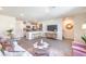 Open-concept living area featuring modern furnishings and an adjacent kitchen with a breakfast bar at 5011 Sage Mesa Ave # Lot 143, Las Vegas, NV 89139