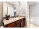 Bathroom featuring granite countertop, updated fixtures, and modern vanity mirror at 5020 Indian River Dr # 424, Las Vegas, NV 89103