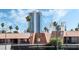 View of building exterior with palm trees and city skyline at 5020 Indian River Dr # 424, Las Vegas, NV 89103