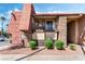 A cozy exterior view showing a two-story condo with stone accents, balcony, and well-kept landscaping at 5020 Indian River Dr # 424, Las Vegas, NV 89103