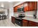 Well-equipped kitchen featuring stainless steel appliances, wood cabinets, and granite countertops at 5020 Indian River Dr # 424, Las Vegas, NV 89103