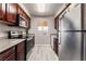 A functional kitchen featuring stainless steel appliances and cherry wood cabinets at 5020 Indian River Dr # 424, Las Vegas, NV 89103