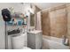 Compact bathroom with a shower-tub combo, gray vanity, and neutral tile at 5112 Pebble Beach Blvd, Las Vegas, NV 89108