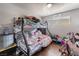 Bedroom with a bunk bed, dark wood floors, and a window providing natural light at 5112 Pebble Beach Blvd, Las Vegas, NV 89108