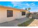 Exterior view of the home with metal security bars on windows, small yard, and walkway to the front door at 5112 Pebble Beach Blvd, Las Vegas, NV 89108