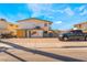 Exterior view of the home showcasing a two-story layout, gravel yard, and parked truck at 5112 Pebble Beach Blvd, Las Vegas, NV 89108
