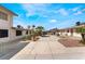 Exterior view of multiple units with palm trees, individual front doors, and open courtyard space at 5112 Pebble Beach Blvd, Las Vegas, NV 89108