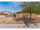 Home exterior with gravel front yard, privacy wall, shade tree, and street view at 5112 Pebble Beach Blvd, Las Vegas, NV 89108