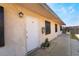 Exterior view of the apartment door with security features and a small garden at 5112 Pebble Beach Blvd, Las Vegas, NV 89108