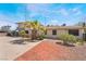 A charming multi-Gathering home with a desert landscape and mature palm tree in the front yard at 5112 Pebble Beach Blvd, Las Vegas, NV 89108