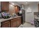 Cozy kitchen featuring a stainless steel refrigerator, double sink and tiled backsplash at 5112 Pebble Beach Blvd, Las Vegas, NV 89108