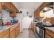Functional kitchen with wood cabinets, updated countertops, and modern appliances at 5112 Pebble Beach Blvd, Las Vegas, NV 89108