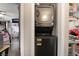 A compact laundry closet with a stacked washer and dryer unit at 5112 Pebble Beach Blvd, Las Vegas, NV 89108