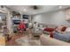Inviting living room featuring a comfortable sofa, wood-look flooring and large TV at 5112 Pebble Beach Blvd, Las Vegas, NV 89108