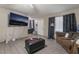 Cozy living room features tile flooring, a TV, and a comfortable sofa at 5112 Pebble Beach Blvd, Las Vegas, NV 89108