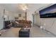 Spacious living room with ceiling fan, tile floors, and a large TV at 5112 Pebble Beach Blvd, Las Vegas, NV 89108