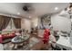 Inviting living room featuring a ceiling fan, sofa and an ornate glass-topped coffee table at 5112 Pebble Beach Blvd, Las Vegas, NV 89108