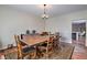 Dining room features wood floors, traditional rug, classic wood dining table and views to the kitchen at 5700 E Carter Ln, Pahrump, NV 89061