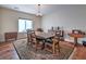 Spacious dining room with wood floors, traditional rug, and classic wood dining table at 5700 E Carter Ln, Pahrump, NV 89061