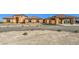 Single-story home with an attached portico, terracotta roof and desert landscaping at 5700 E Carter Ln, Pahrump, NV 89061