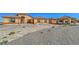 Attractive single-story stucco home with a covered entryway and desert landscaping at 5700 E Carter Ln, Pahrump, NV 89061