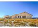 The exterior of this lovely desert home has a covered patio perfect for enjoying the views at 5700 E Carter Ln, Pahrump, NV 89061