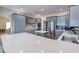 Modern kitchen features gray cabinets, stainless steel appliances, quartz countertops, and mosaic backsplash at 5700 E Carter Ln, Pahrump, NV 89061