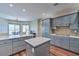 Modern kitchen features gray cabinets, quartz countertops, and stainless steel appliances at 5700 E Carter Ln, Pahrump, NV 89061