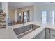 Kitchen with stainless steel sink, quartz countertops and views to the living room at 5700 E Carter Ln, Pahrump, NV 89061