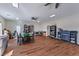 Spacious living area featuring wood flooring, multiple ceiling fans and abundant light at 5700 E Carter Ln, Pahrump, NV 89061