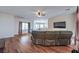 Open living space with hardwood floors, modern ceiling fan, and flatscreen TV at 5700 E Carter Ln, Pahrump, NV 89061