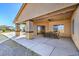 This home boasts a large, covered patio with a ceiling fan perfect for relaxing and enjoying the desert views at 5700 E Carter Ln, Pahrump, NV 89061