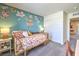 Bright bedroom featuring a daybed, stylish accent wall, and ample closet space at 6104 Aster Garden St # 129, North Las Vegas, NV 89081
