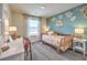Charming bedroom with a daybed, floral wallpaper, and a bright, airy atmosphere at 6104 Aster Garden St # 129, North Las Vegas, NV 89081