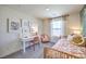 Bright bedroom featuring a daybed, desk, soft decor, and plenty of natural light at 6104 Aster Garden St # 129, North Las Vegas, NV 89081