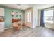 Bright dining area with a unique accent wall, modern furnishings, and plenty of natural light at 6104 Aster Garden St # 129, North Las Vegas, NV 89081