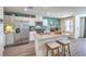 Spacious kitchen and dining area with island, stainless steel appliances, and stylish decor at 6104 Aster Garden St # 129, North Las Vegas, NV 89081