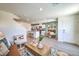 Open-concept kitchen featuring white cabinets, a center island, and modern appliances at 6104 Aster Garden St # 129, North Las Vegas, NV 89081