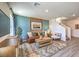 Beautifully decorated living room with modern furniture, stylish rug, and vibrant accent wall at 6104 Aster Garden St # 129, North Las Vegas, NV 89081