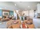 Open concept living space with modern decor, including a dining area, living room, and kitchen at 6104 Aster Garden St # 129, North Las Vegas, NV 89081