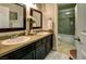 Bathroom with double sink vanity, marble countertop and shower with glass doors at 614 Ravenglen Dr, Las Vegas, NV 89123
