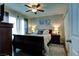 Primary bedroom featuring a queen bed, ceiling fan and bedside tables at 614 Ravenglen Dr, Las Vegas, NV 89123
