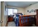 Cozy bedroom featuring a queen-sized bed with blue bedding and a wooden frame at 614 Ravenglen Dr, Las Vegas, NV 89123