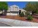 Charming two-story home featuring an attached three-car garage and well-maintained landscaping at 614 Ravenglen Dr, Las Vegas, NV 89123